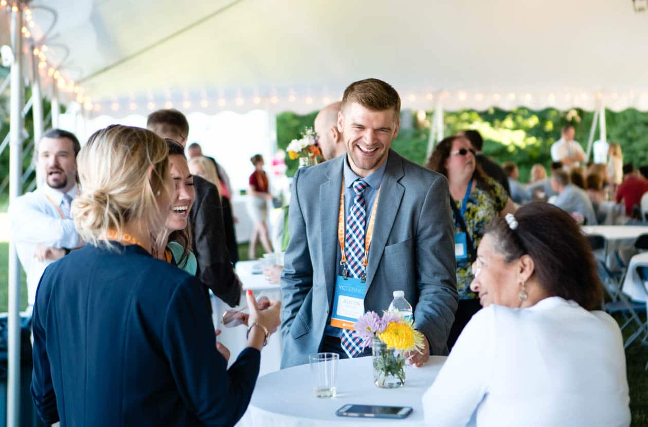 Small table of people chatting at an outdoor event