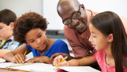 Teacher helping students do work