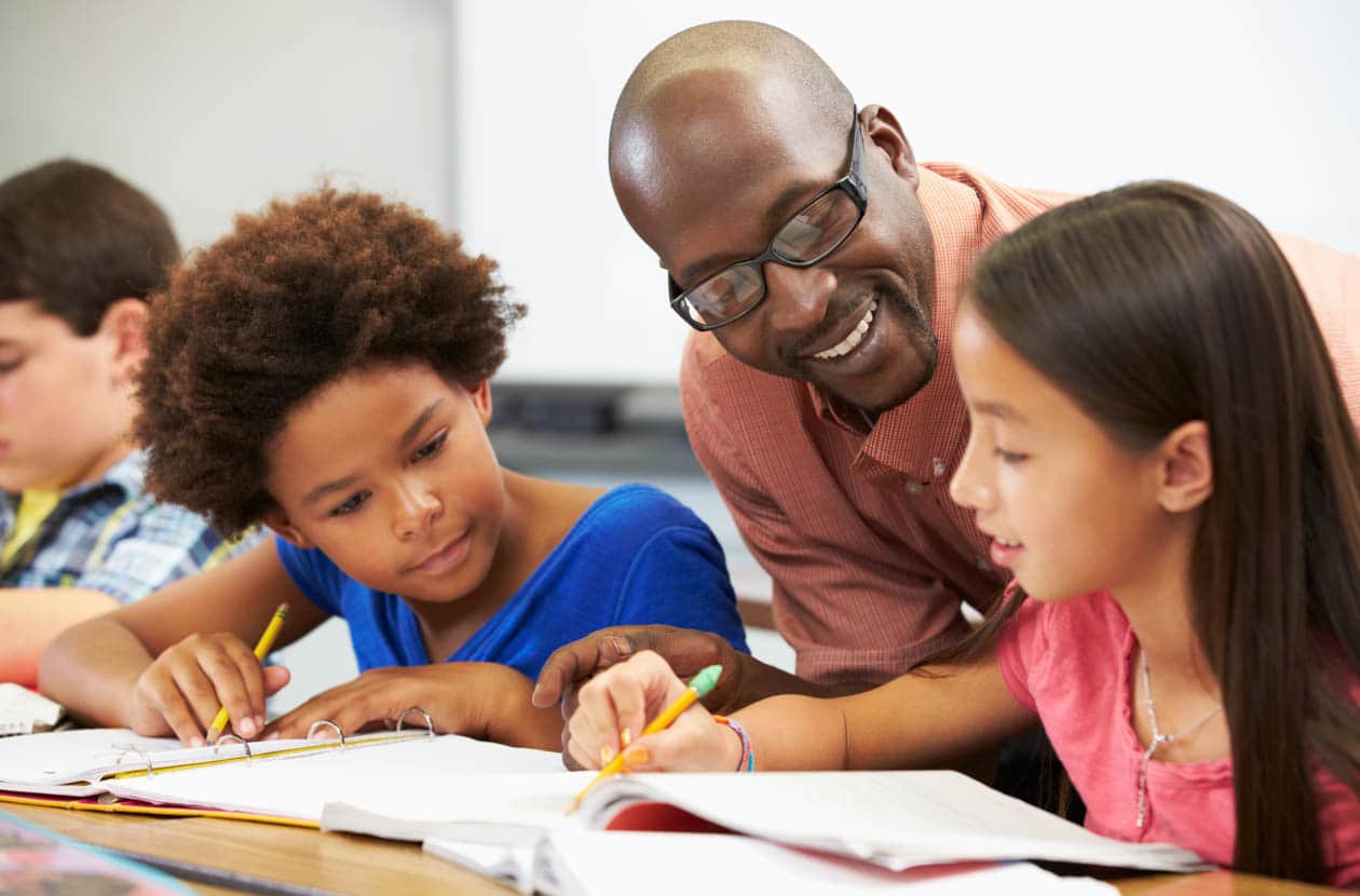 Teacher helping students do work