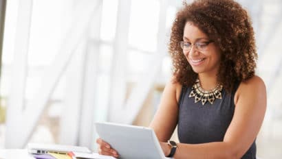 Woman sitting at a table looking over notes