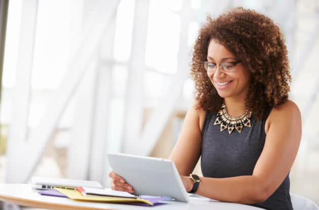 Woman sitting at a table looking over notes