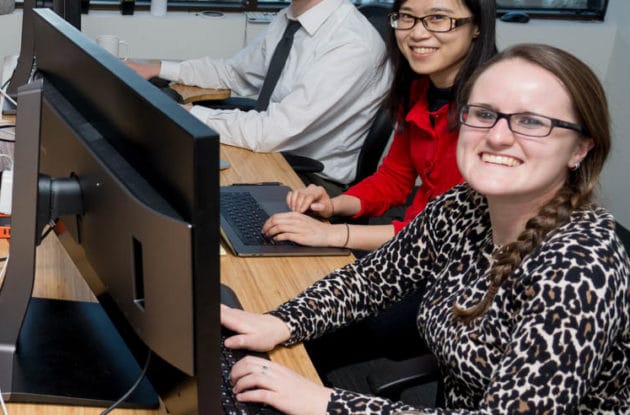 Veracross employees working at their computers