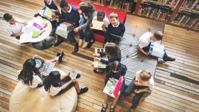 Students in library smiling