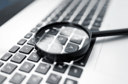 Image of magnifying glass on computer keyboard