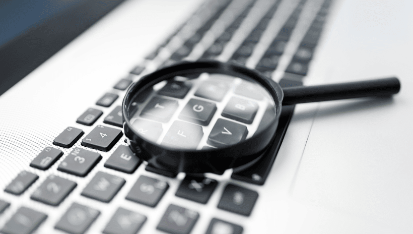 Image of magnifying glass on computer keyboard