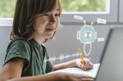 School-aged boy using computer with image of robot
